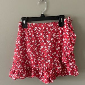 Japna red skort with white flowers and a bow to the side